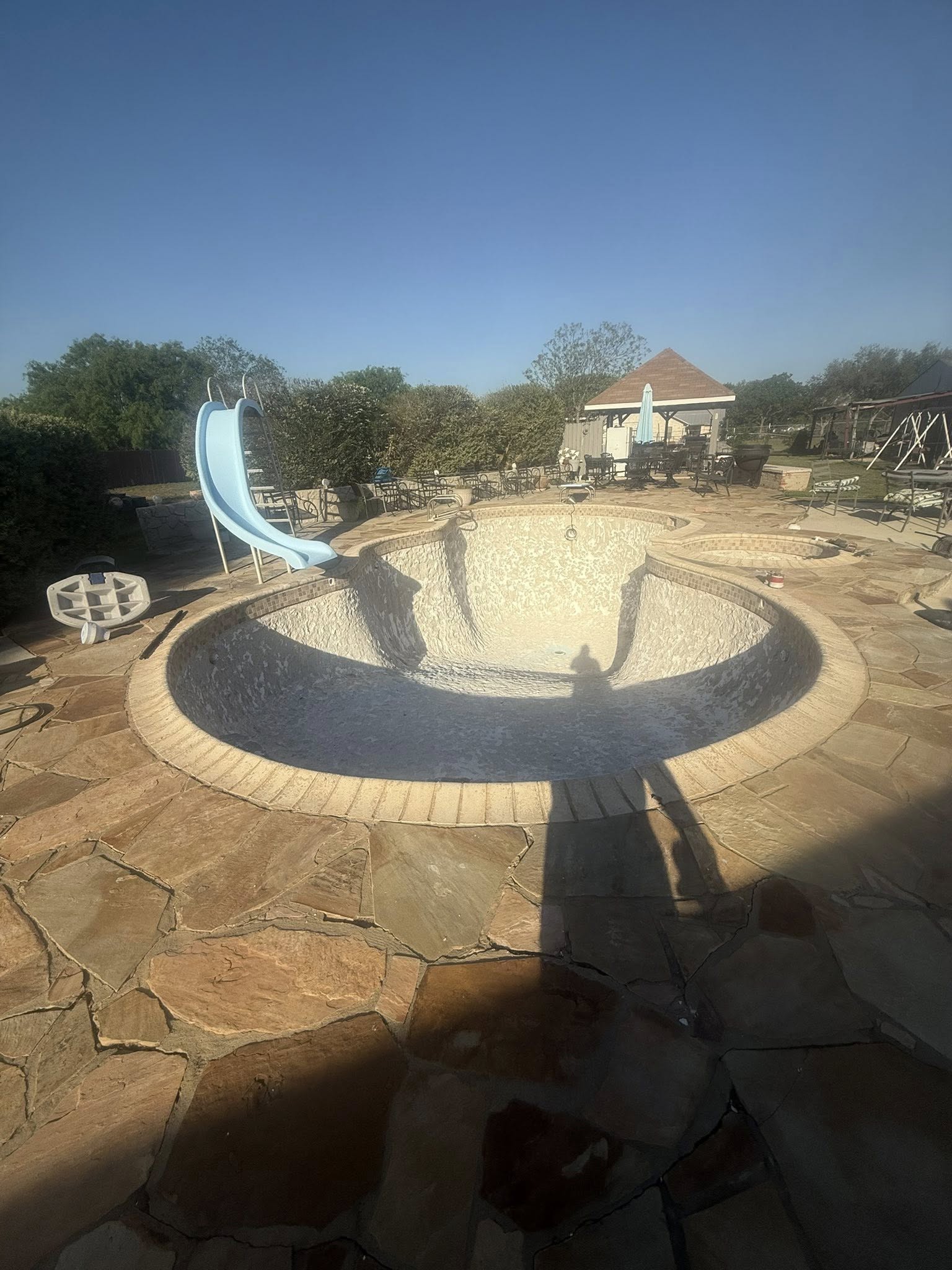 Pool with slide and flagstone patio