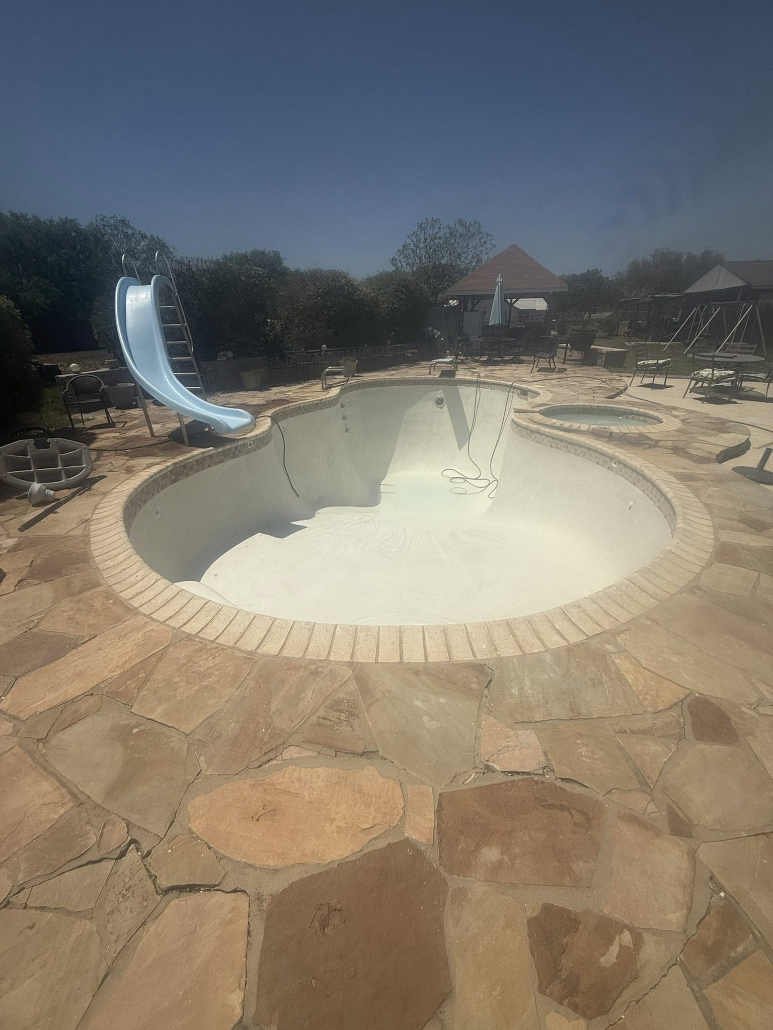 Pool drained with slide, another angle