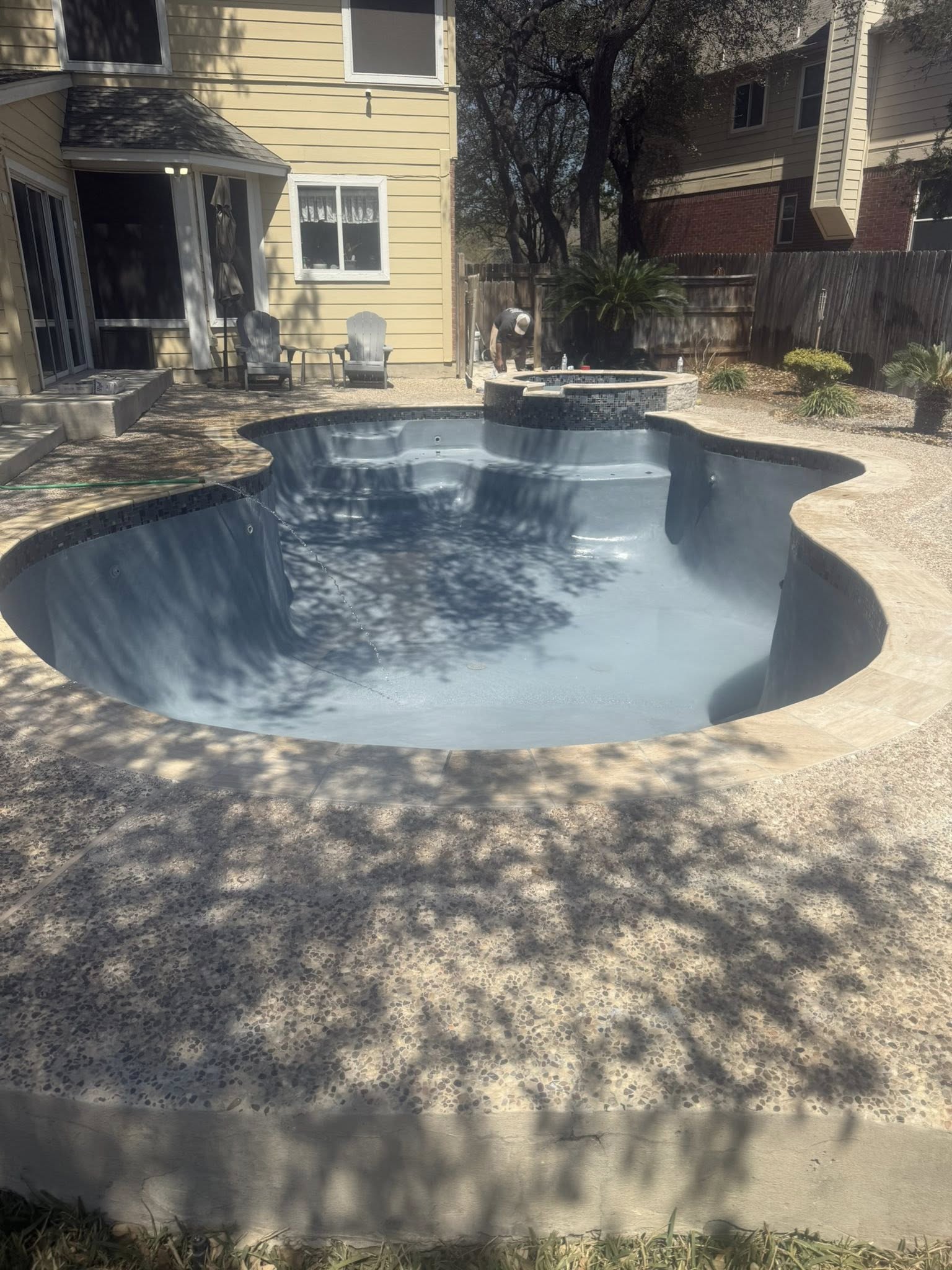 Freeform pool with dark plaster finish