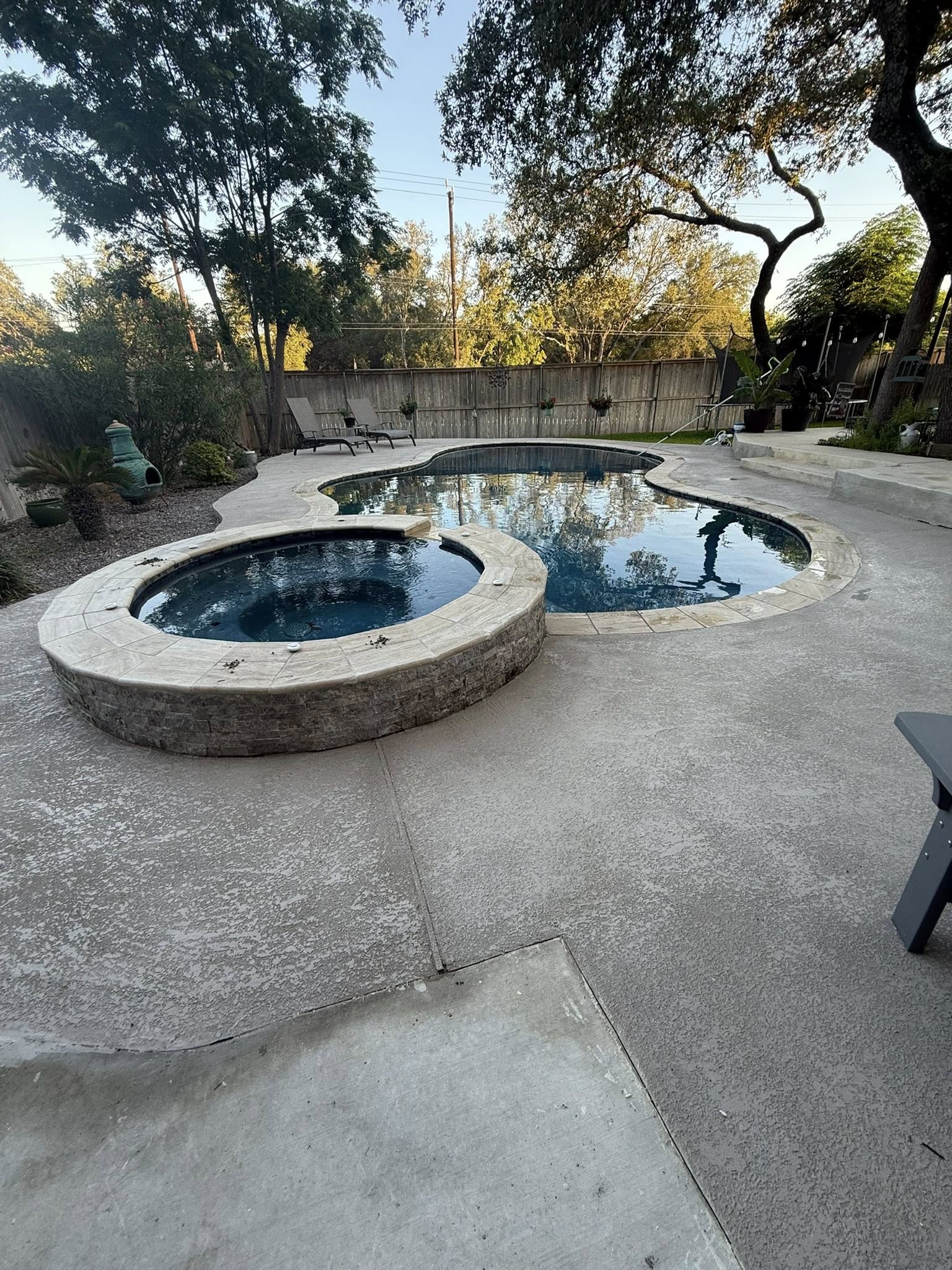 Finished pool with spa and trees